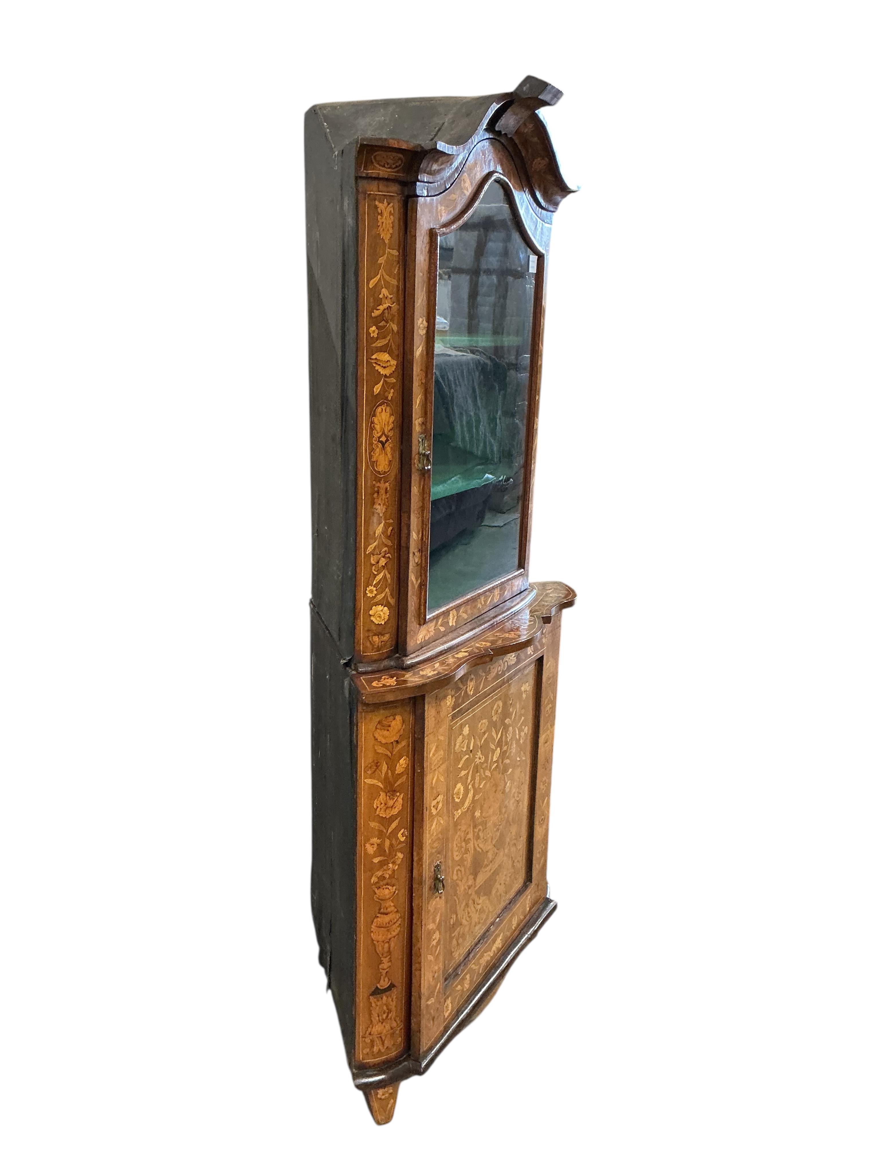 An early 19th century Dutch floral marquetry inlaid walnut standing corner cabinet, width 87cm, depth 53cm, height 192cm
